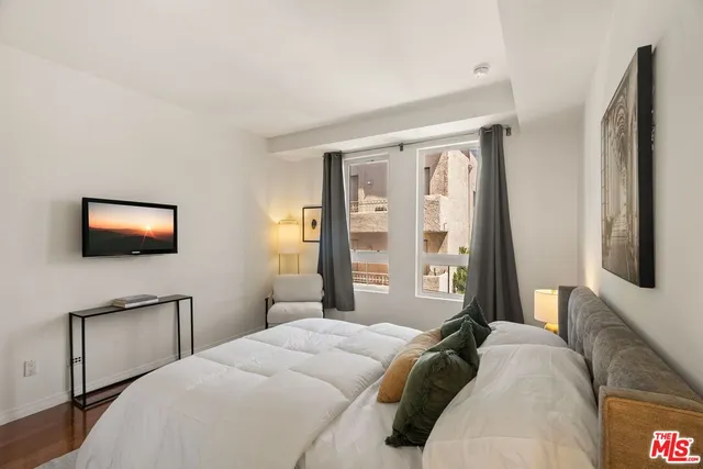 a bedroom with a bed and a flat screen tv