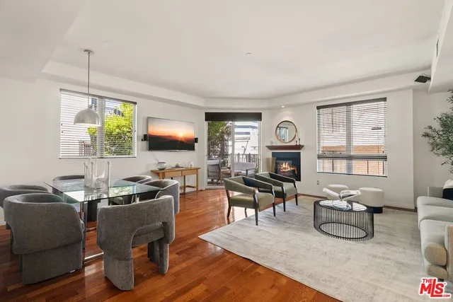 a living room with furniture flat screen tv and window