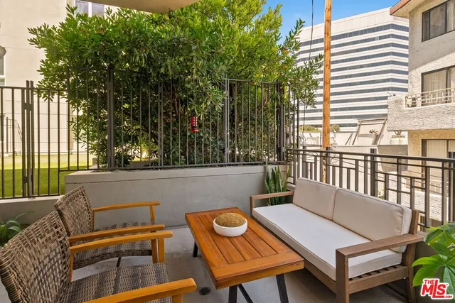 a view of a patio with a table and chairs