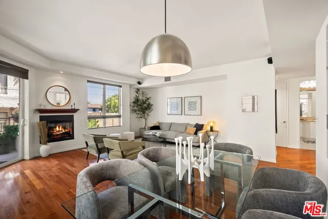 a living room with furniture a fireplace and a window