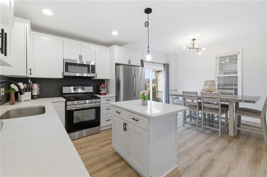 1535 Vance Avenue Coraopolis, PA 15108 - Photo 20 of 38 a kitchen with stainless steel appliances white cabinets a sink a stove a refrigerator and island