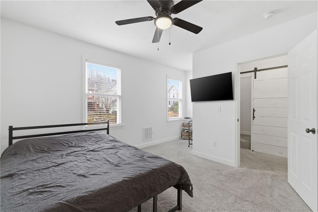 1535 Vance Avenue Coraopolis, PA 15108 - Photo 24 of 38 a bedroom with a bed and a flat screen tv