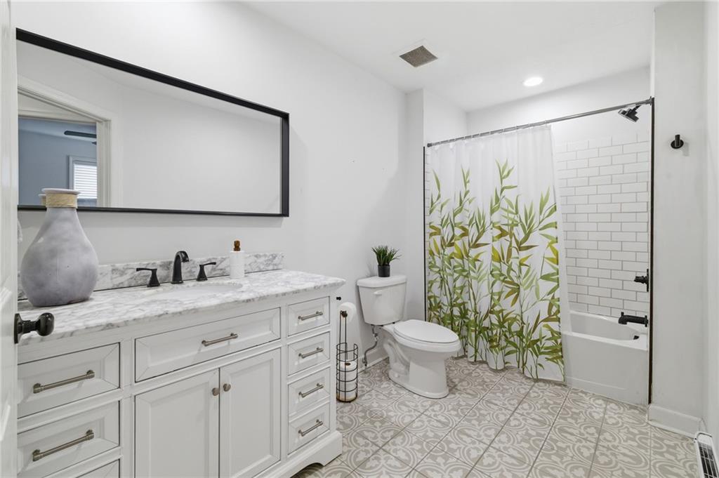 1535 Vance Avenue Coraopolis, PA 15108 - Photo 26 of 38 a bathroom with a granite countertop sink a toilet and a mirror