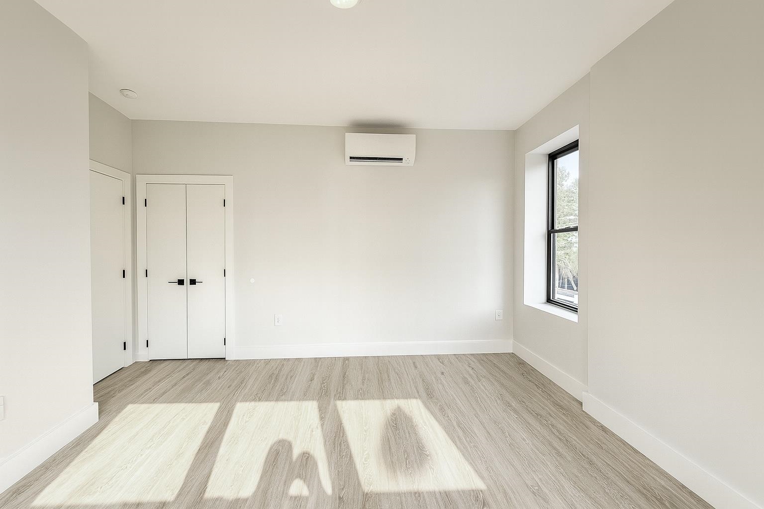 103 Bostwick Avenue, Unit 3A Jersey City, NJ 07305 - Photo 14 of 18 a view of room with window and wooden floor