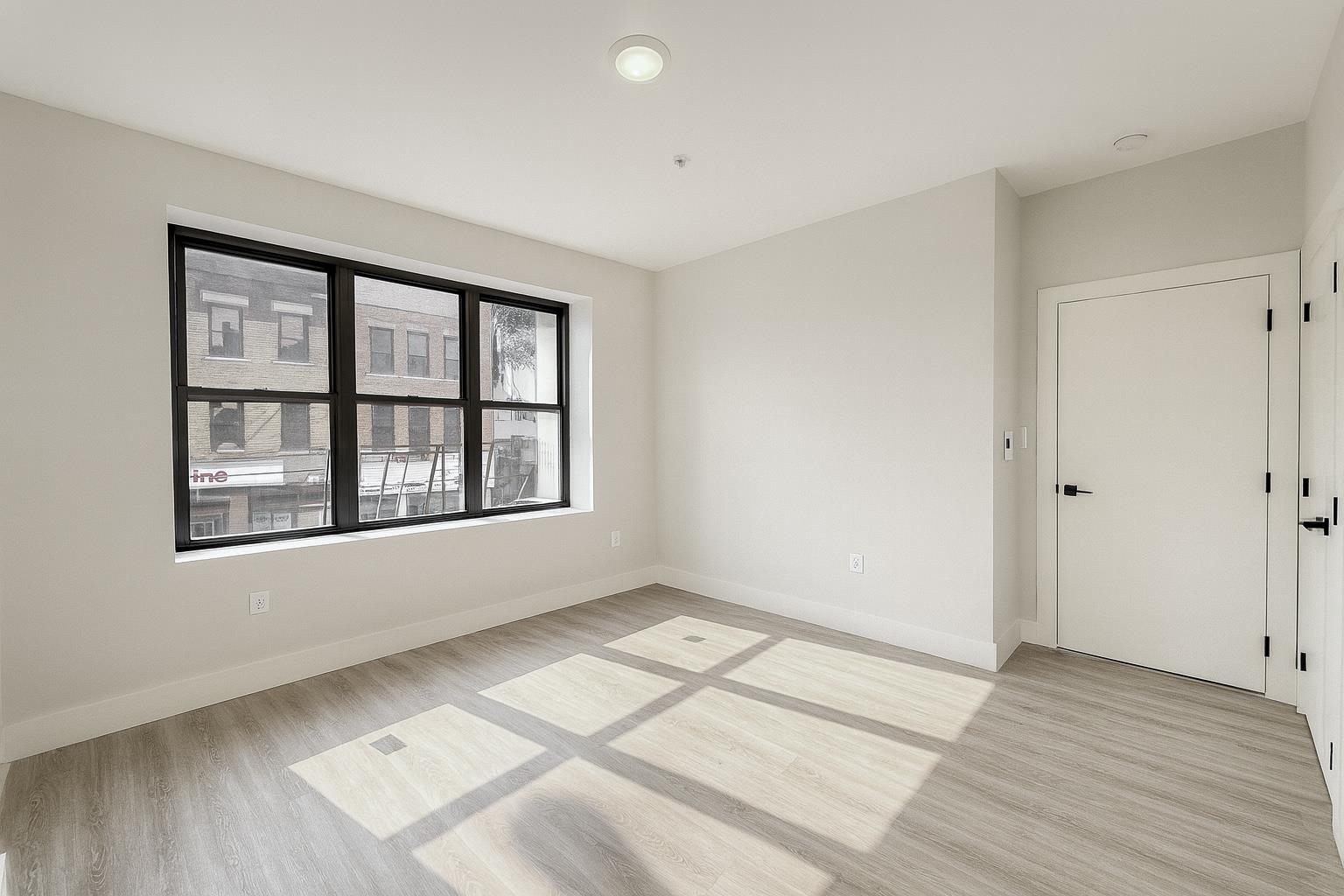 103 Bostwick Avenue, Unit 3A Jersey City, NJ 07305 - Photo 15 of 18 a view of an empty room with a window