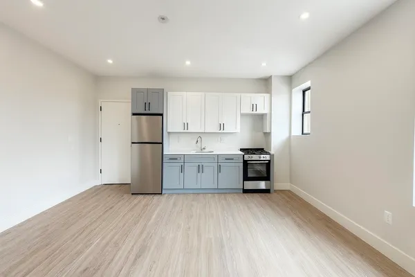 a kitchen with stainless steel appliances a refrigerator and a stove top oven