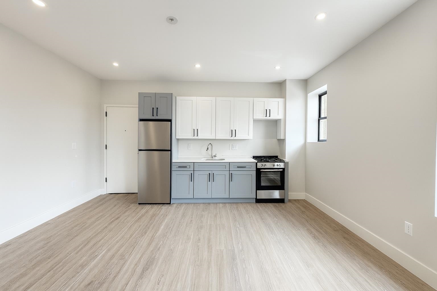 103 Bostwick Avenue, Unit 3A Jersey City, NJ 07305 - Photo 2 of 18 a kitchen with stainless steel appliances a refrigerator and a stove top oven