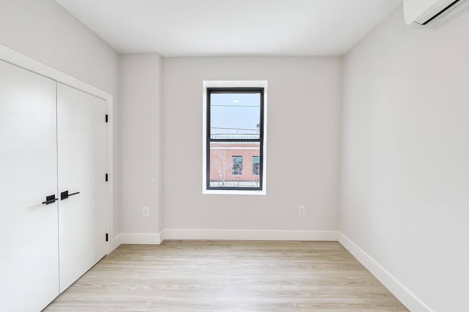 103 Bostwick Avenue, Unit 3A Jersey City, NJ 07305 - Photo 5 of 18 an empty room with a window