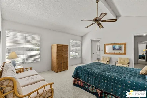 a bedroom with a bed and ceiling fan