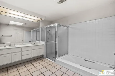 a bathroom with a shower sink and mirror