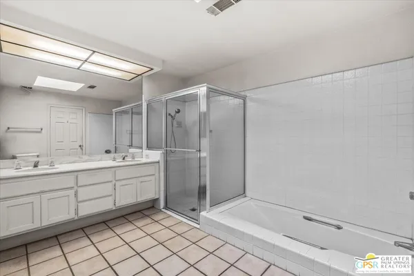 a bathroom with a shower sink and mirror