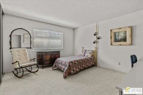 a spacious bedroom with a bed and a couch