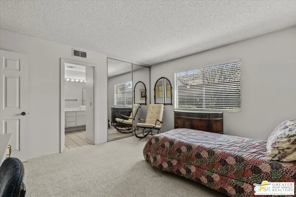a bedroom with a large bed and a window