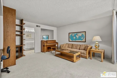 a living room with furniture and a lamp