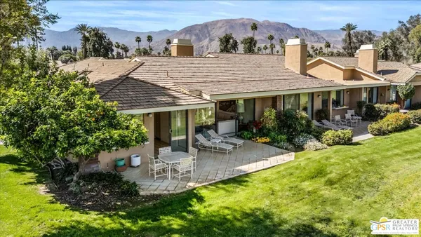 a front view of house with yard and outdoor seating