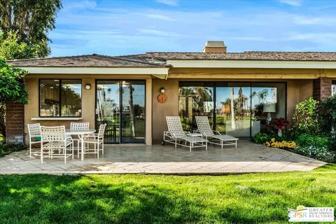a view of a patio with table and chairs and potted plants