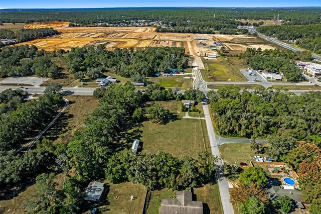 an aerial view of residential houses with outdoor space and river view
