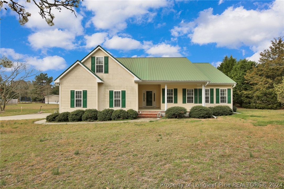 10703 Aberdeen Road Aberdeen, NC 28315 - Photo 1 of 33 a front view of a house with a yard