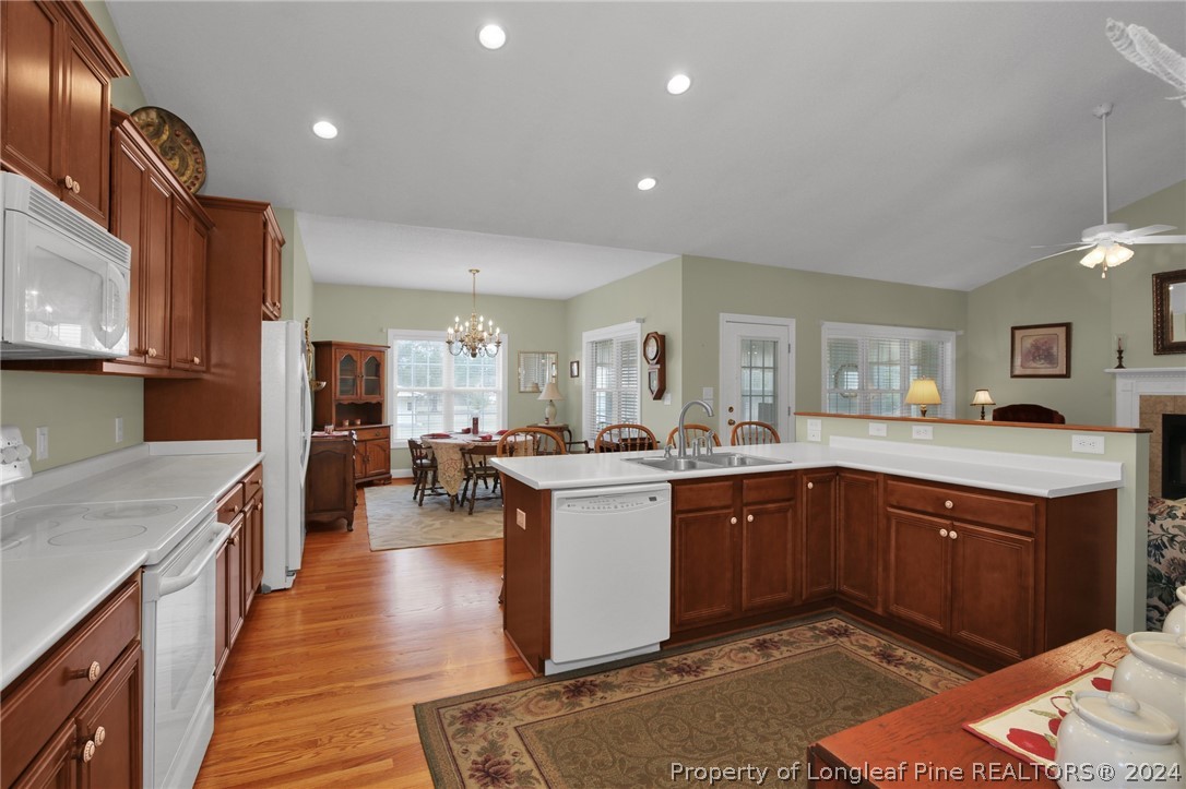 10703 Aberdeen Road Aberdeen, NC 28315 - Photo 12 of 33 a kitchen with a sink stove and wooden cabinets