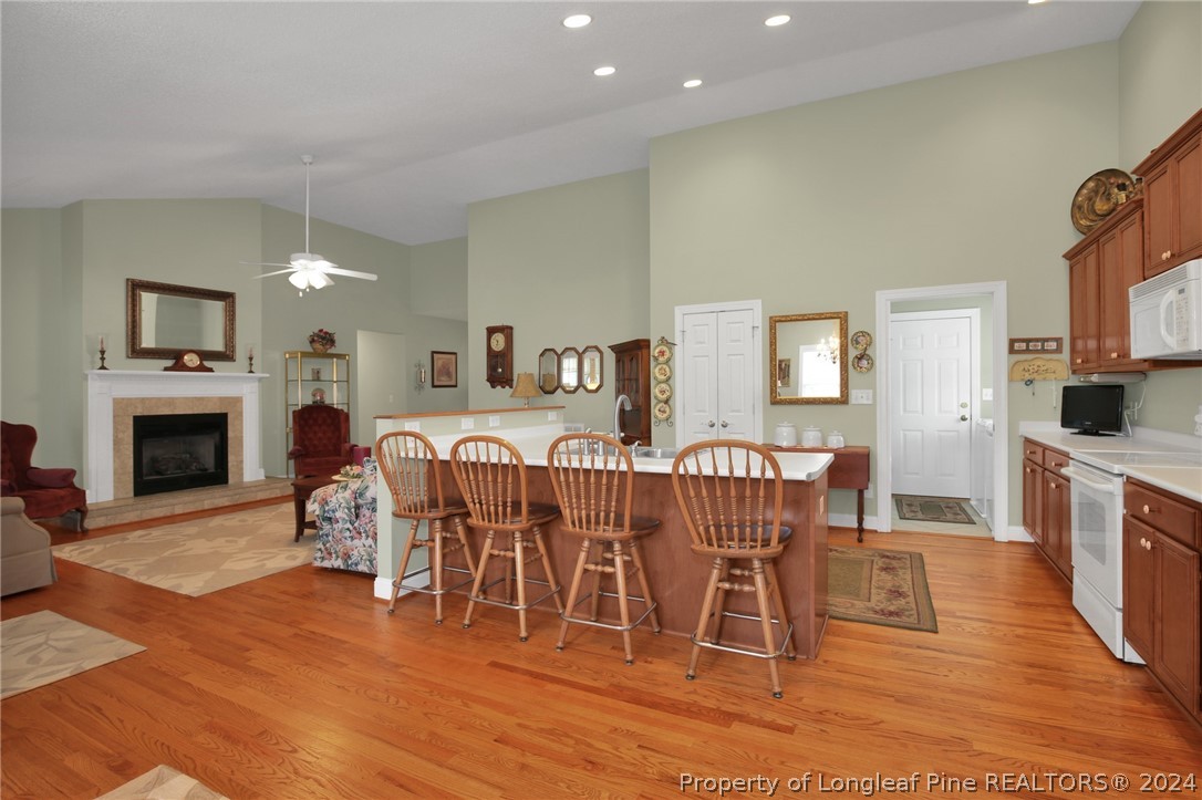 10703 Aberdeen Road Aberdeen, NC 28315 - Photo 13 of 33 a dining room with furniture a fireplace and wooden floor