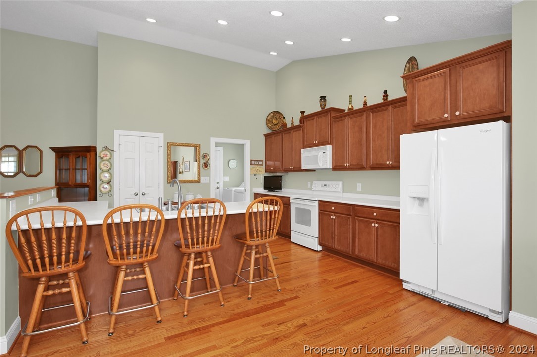 10703 Aberdeen Road Aberdeen, NC 28315 - Photo 14 of 33 a kitchen with stainless steel appliances granite countertop a table chairs and a refrigerator