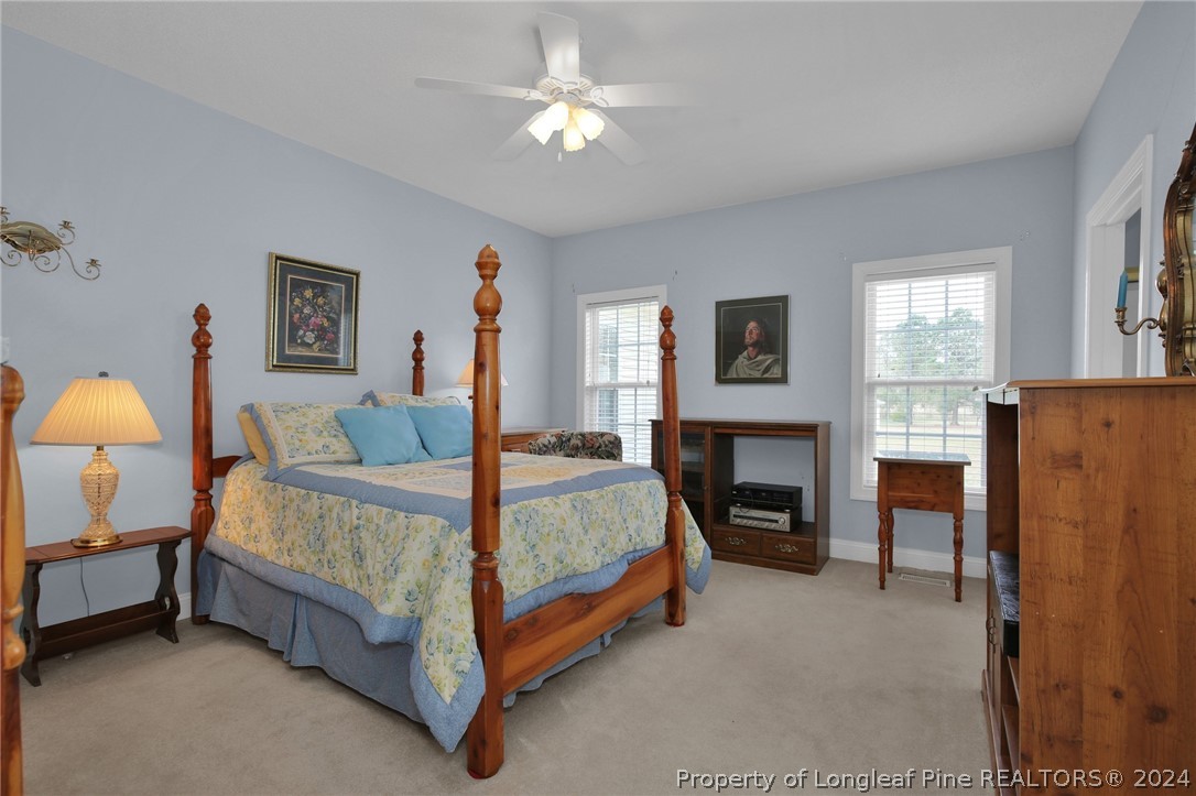 10703 Aberdeen Road Aberdeen, NC 28315 - Photo 17 of 33 a bed room with a bed and a fireplace