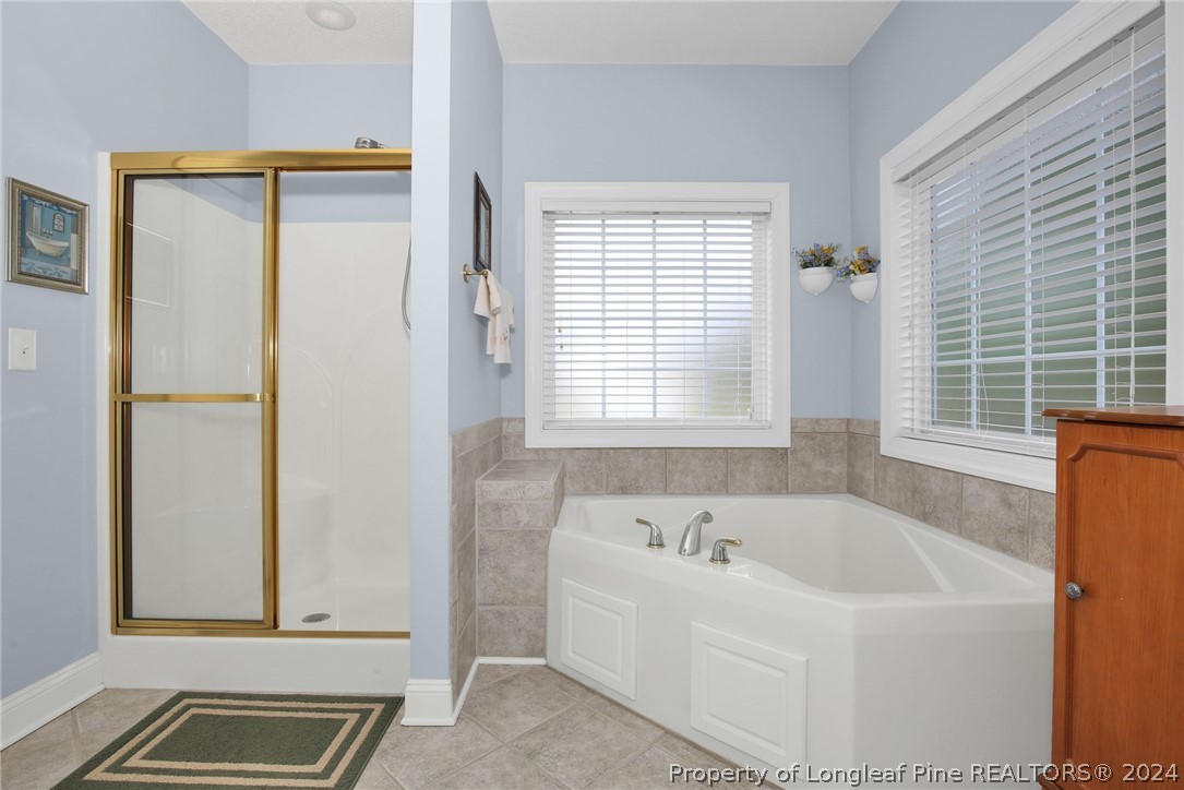 10703 Aberdeen Road Aberdeen, NC 28315 - Photo 20 of 33 a bathroom with a bathtub and a shower