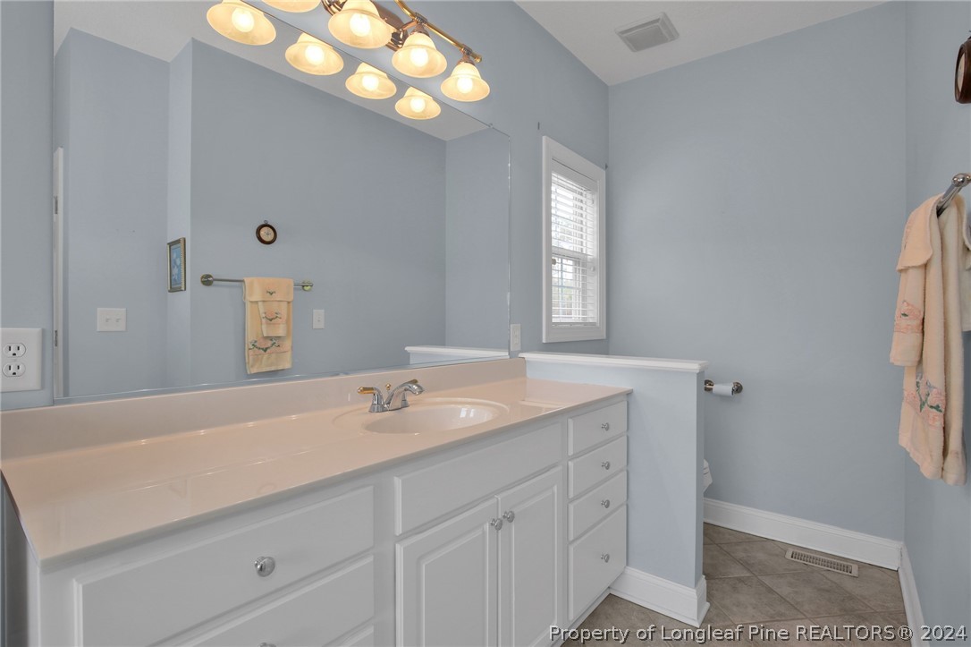 10703 Aberdeen Road Aberdeen, NC 28315 - Photo 21 of 33 a spacious bathroom with double vanity and a mirror