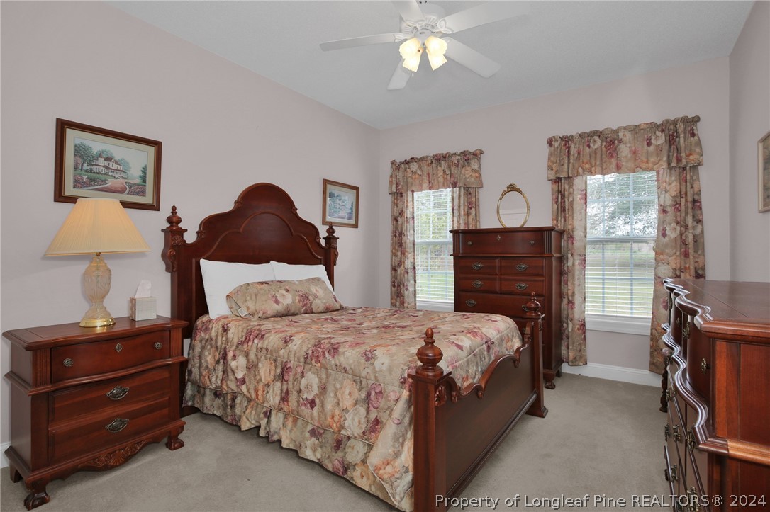 10703 Aberdeen Road Aberdeen, NC 28315 - Photo 23 of 33 a bedroom with a bed and dresser with mirror