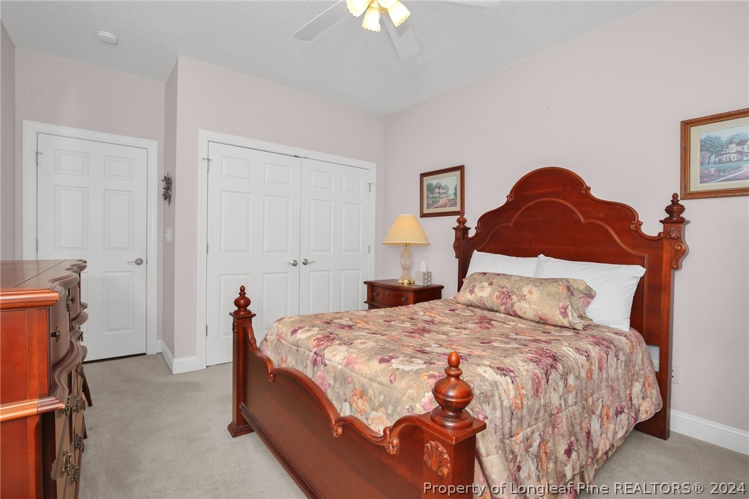 10703 Aberdeen Road Aberdeen, NC 28315 - Photo 24 of 33 a bedroom with a bed and a lamp