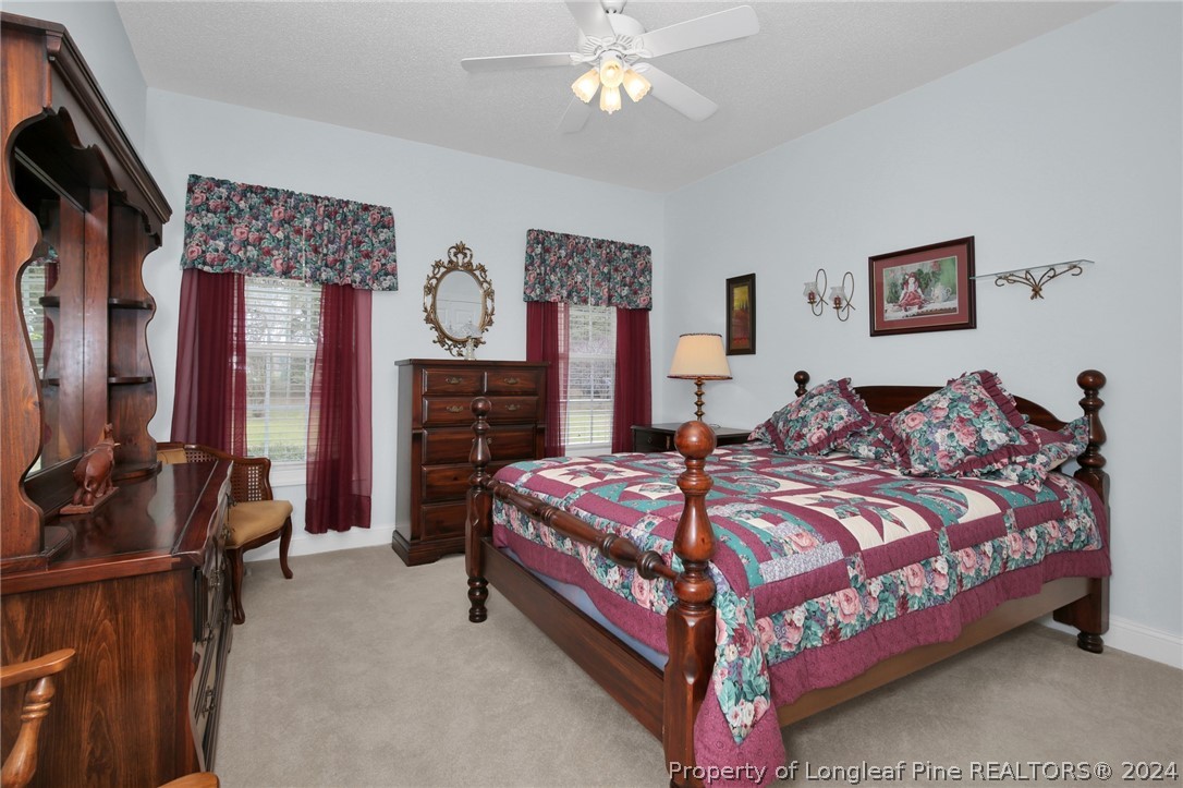 10703 Aberdeen Road Aberdeen, NC 28315 - Photo 25 of 33 a bedroom with a bed and a chandelier