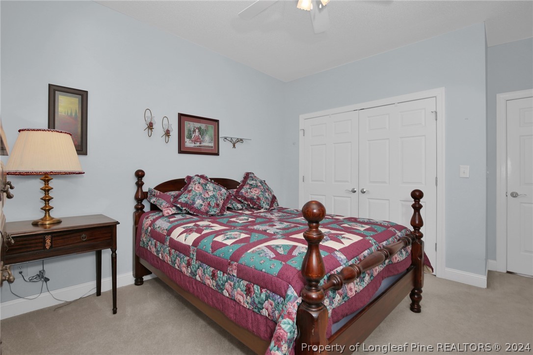 10703 Aberdeen Road Aberdeen, NC 28315 - Photo 26 of 33 a bedroom with a bed and a lamp on dresser