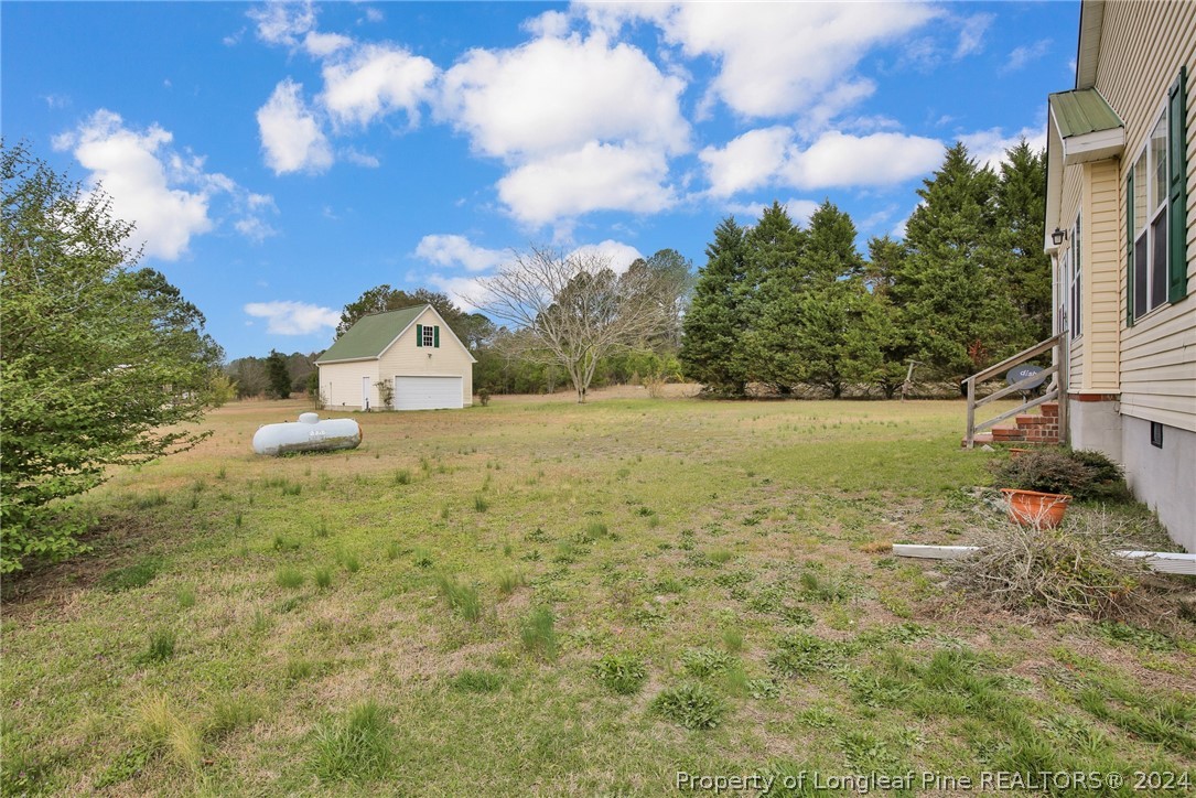 10703 Aberdeen Road Aberdeen, NC 28315 - Photo 29 of 33 a view of a field with a house in the background