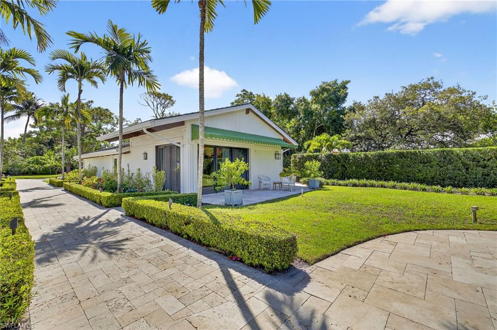 111 Caribbean Road Naples, FL 34108 - Photo 41 of 50 a front view of house with yard and green space