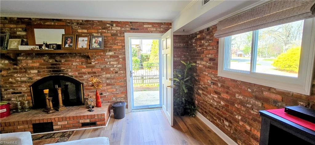 105 Mendenhall Road Jamestown, NC 27282 - Photo 19 of 42 Snuggle up in front of the woodburning fireplace in lower level. It is believed that the bricks in this home were salvaged from a hospital in Chicago