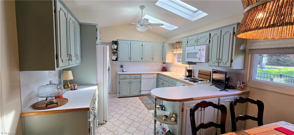 105 Mendenhall Road Jamestown, NC 27282 - Photo 2 of 42 Freshly painted cabinets enhance the beauty of this well lit kitchen with sunlights