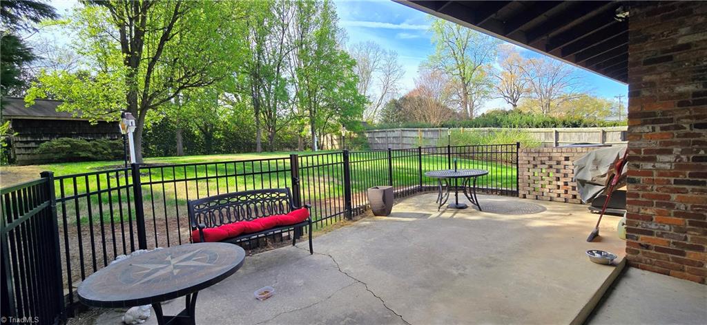 105 Mendenhall Road Jamestown, NC 27282 - Photo 25 of 42 Relax on this spacious patio overlooking large backyard. Yard backs up to Wrenn Miller Park but privacy abounds with greenery divider