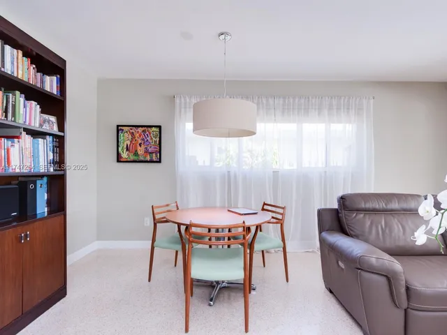 a dining room with furniture and a book shelf