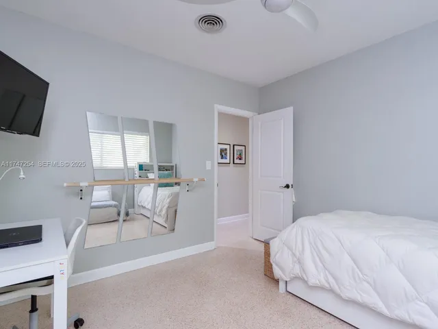 a bathroom with a sink toilet vanity and shower