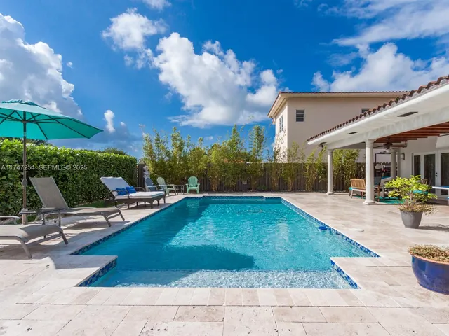 a view of a chairs and table in the patio