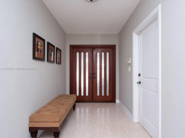 a view of a room that has a window and a chair