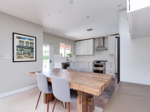a kitchen with a table and chairs in it