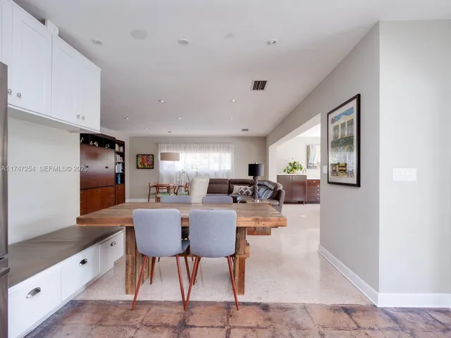 a large kitchen with a table and chairs in it