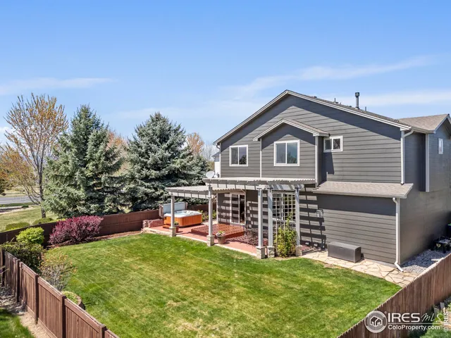 a view of a house with a yard and sitting area