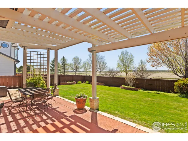 a view of a backyard with sitting area