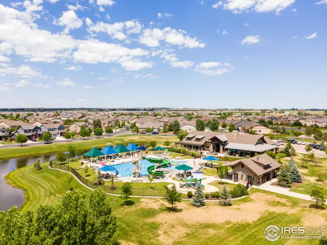 a view of a swimming pool with outdoor seating and yard in back