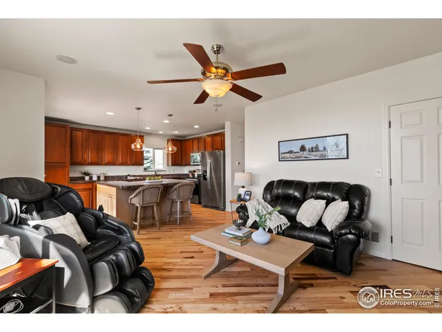 a living room with furniture and kitchen view