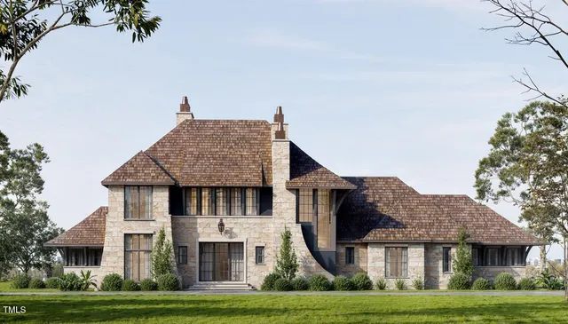 a front view of a house with a garden and plants