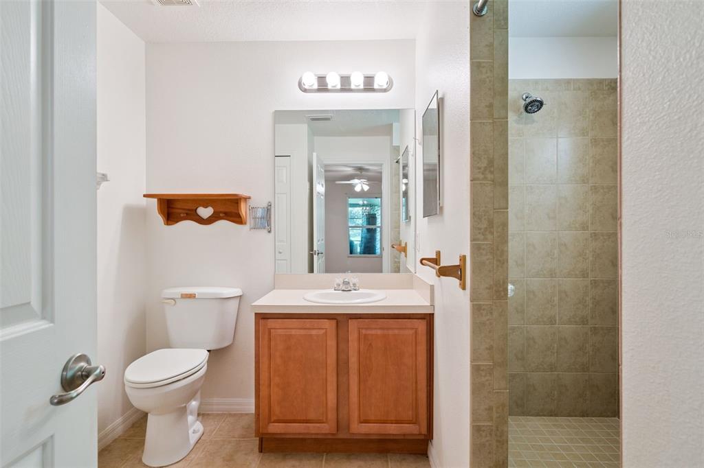 420 Jacks Memorial Road St. Cloud, FL 34769 - Photo 12 of 31 a bathroom with a toilet sink vanity and mirror