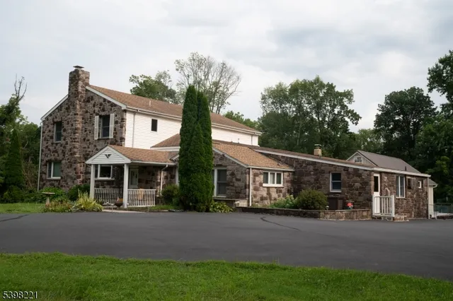 a front view of a house with yard and green space
